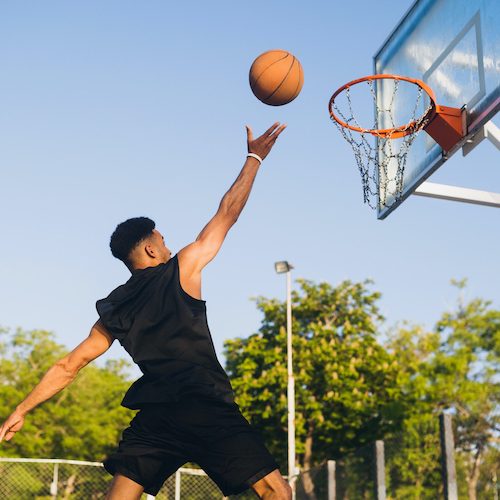 cool-black-man-doing-sports-playing-basketball-sunrise-jumping